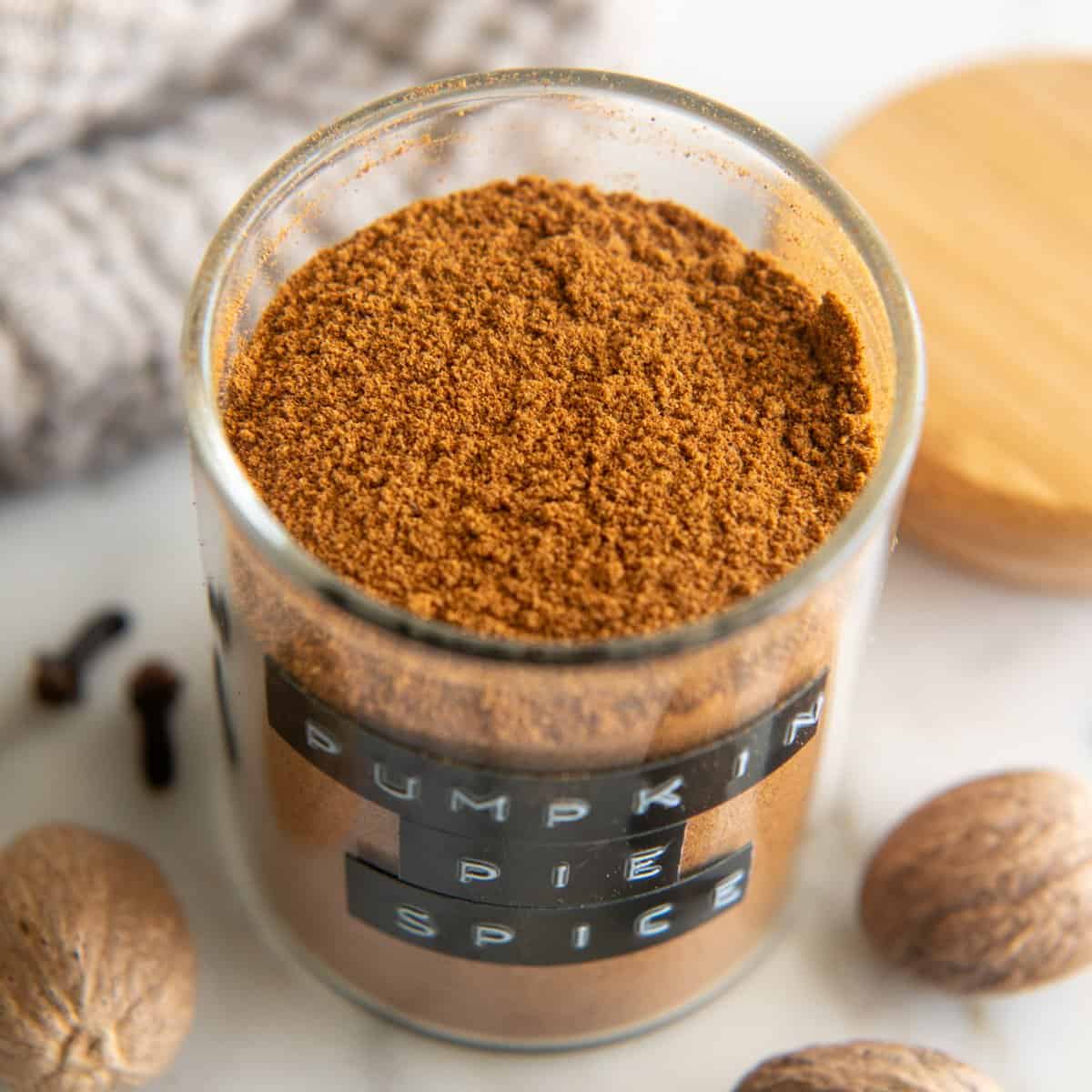 an open glass jar of Homemade Pumpkin Pie Spice with a black label 